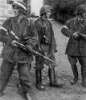 Polish resistance fighters Wojciech Omyla, Juliusz Bogdan Deczkowski, and Tadeusz Milewski in captured German uniforms and Kar98k rifles, Warsaw, Poland, 5 Aug 1944. 